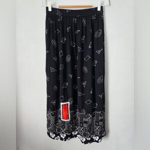 GLOBE TROTTER Black Patterned Skirt with Red Accent